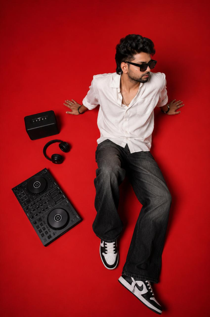 DJ Arush on Red Studio Floor with Equipment